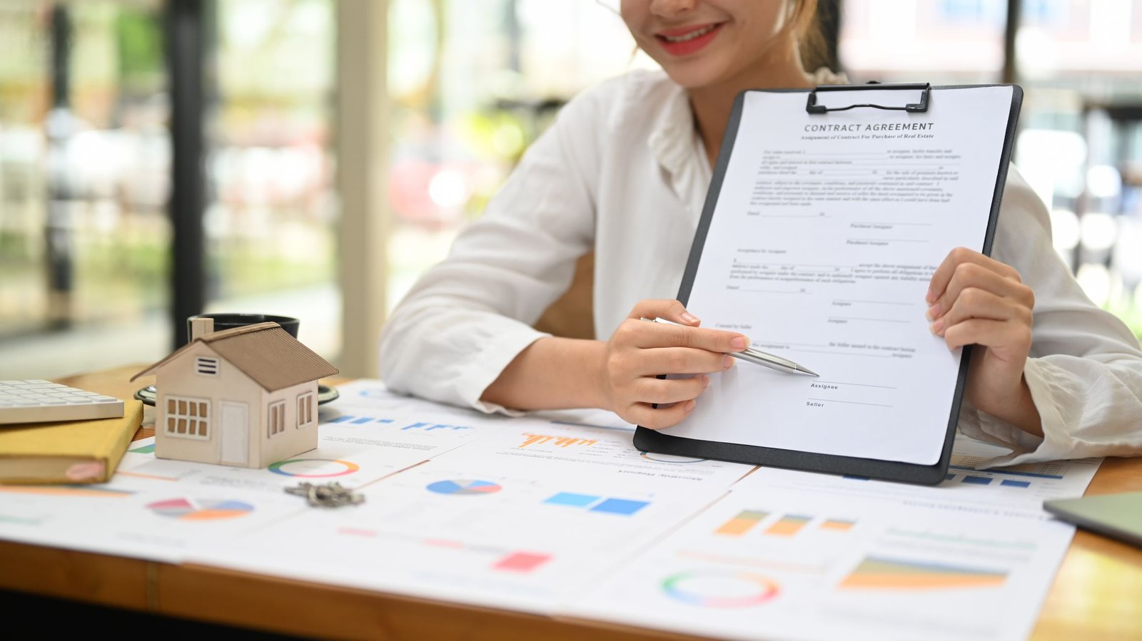 Young female real estate agent consulting with clients about abo